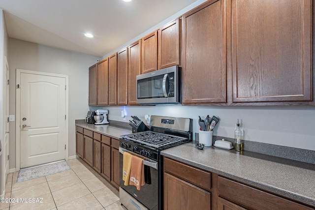 kitchen featuring light tile patterned floors and stainless steel appliances