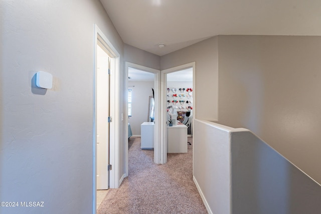 hallway featuring light carpet