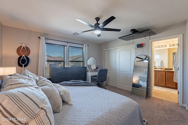 carpeted bedroom featuring connected bathroom, ceiling fan, and a closet