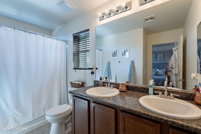 bathroom featuring tile patterned flooring, vanity, and toilet