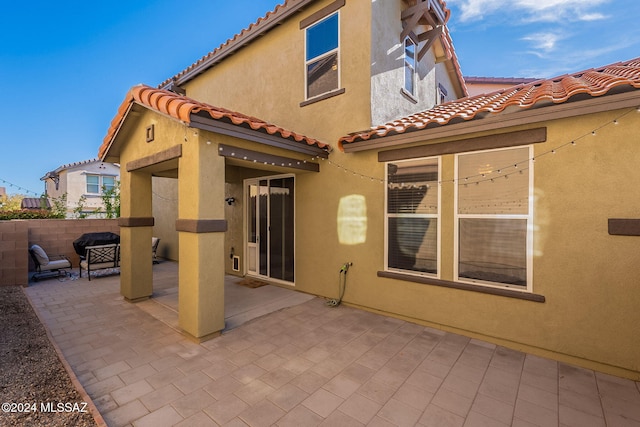 back of house with a patio area