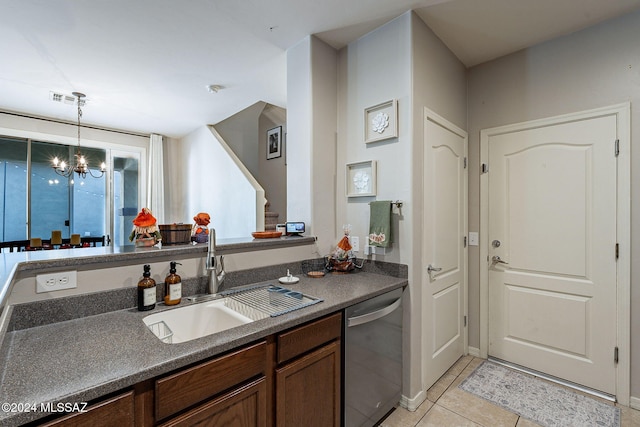 kitchen featuring stainless steel dishwasher, sink, light tile patterned floors, an inviting chandelier, and hanging light fixtures