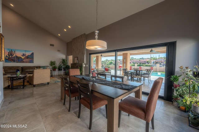 dining room with high vaulted ceiling