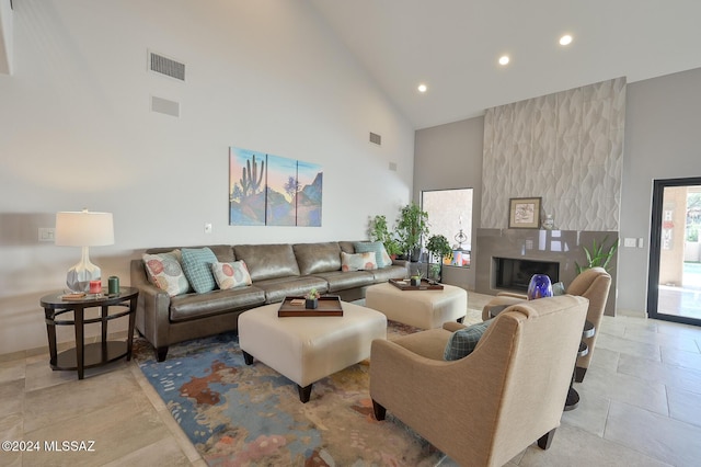 living room featuring high vaulted ceiling and a fireplace