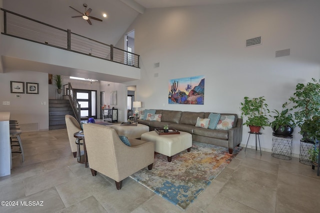 living room with beamed ceiling, ceiling fan with notable chandelier, and high vaulted ceiling