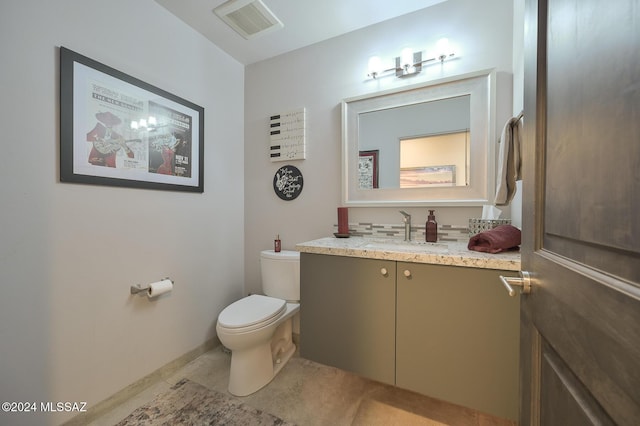 bathroom featuring toilet, tile patterned floors, and vanity