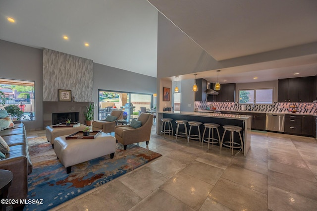 living room featuring a large fireplace and high vaulted ceiling