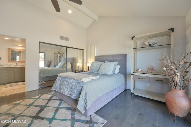 bedroom featuring vaulted ceiling with beams, a closet, dark hardwood / wood-style flooring, and connected bathroom