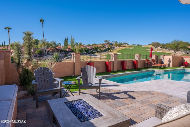 view of swimming pool with an outdoor fire pit and a patio