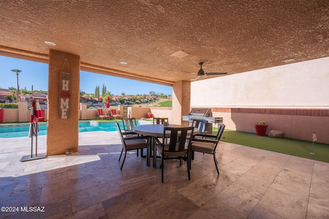 view of patio with ceiling fan, a grill, and a fenced in pool