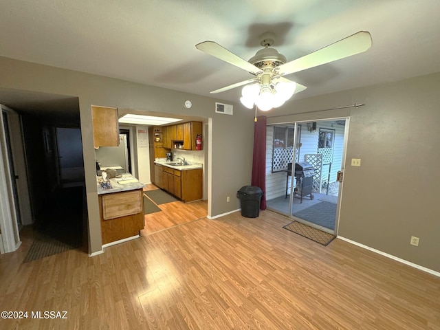 kitchen featuring light hardwood / wood-style flooring, ceiling fan, and sink