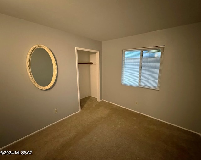 unfurnished bedroom featuring carpet and a closet