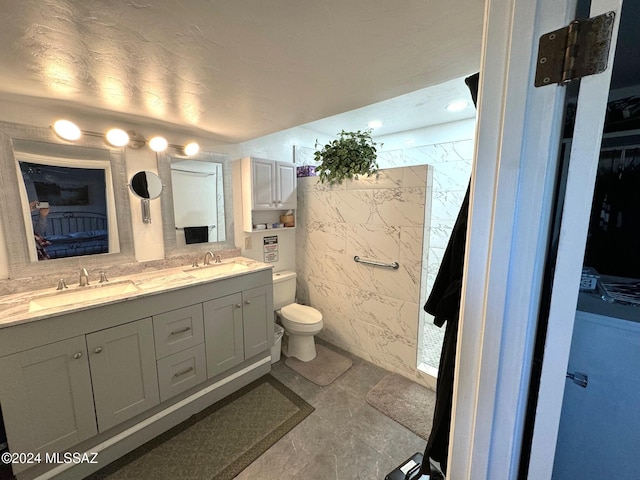 bathroom with tile patterned floors, vanity, and toilet