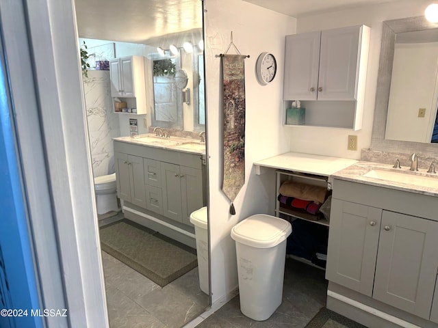 bathroom with tile patterned flooring, vanity, and toilet