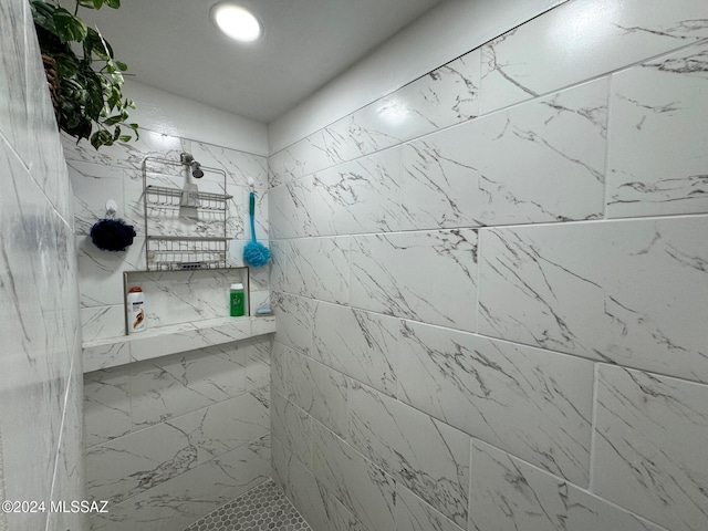 bathroom with a tile shower