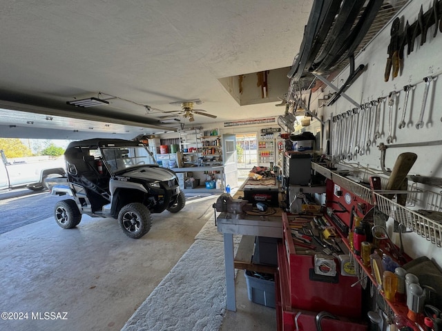 garage featuring a workshop area and ceiling fan