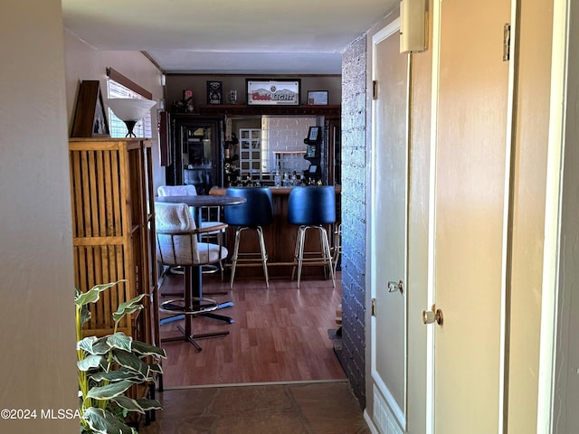 bar with dark wood-type flooring