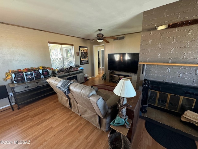 living room with ceiling fan and light hardwood / wood-style floors