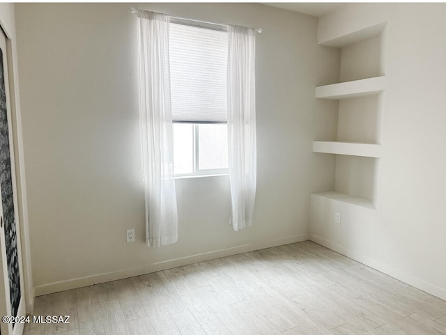 spare room with light hardwood / wood-style floors