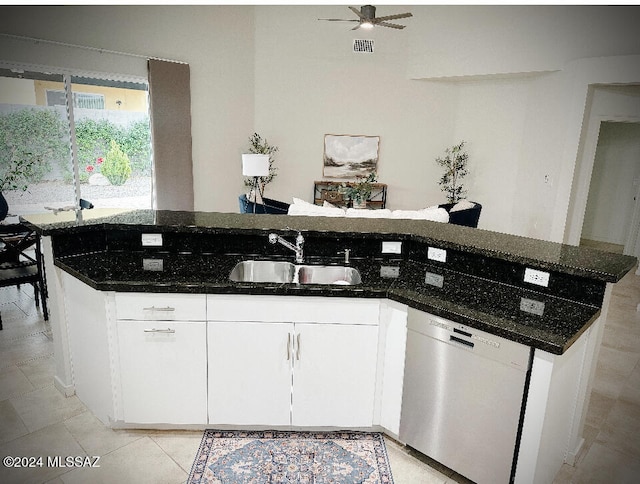 kitchen with ceiling fan, dishwasher, sink, dark stone counters, and white cabinets