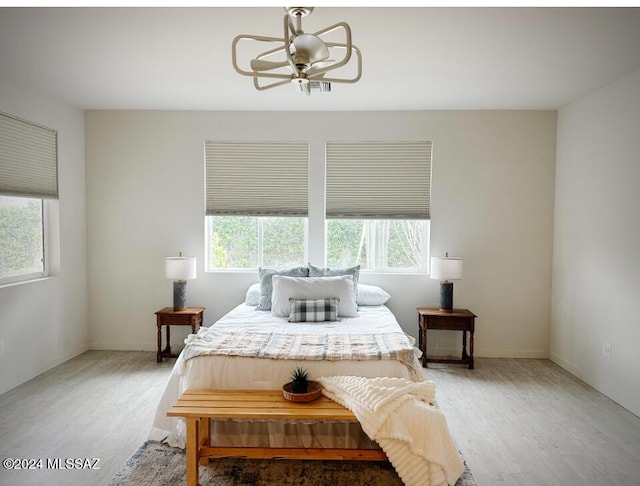 bedroom featuring wood-type flooring and multiple windows