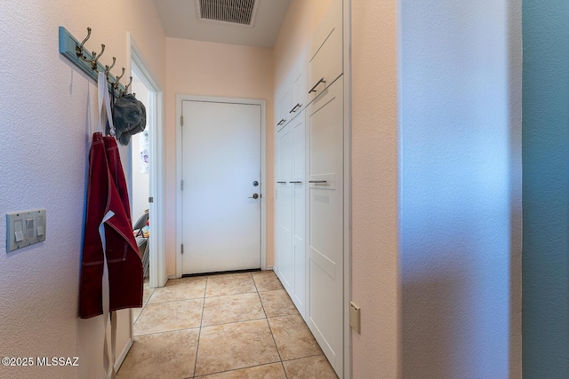 hall with light tile patterned floors