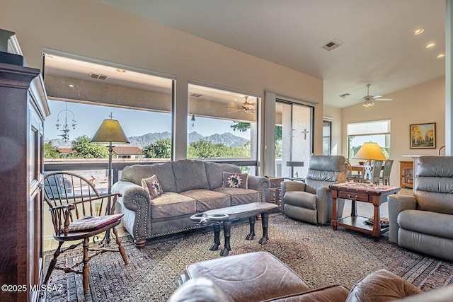 living room featuring ceiling fan, lofted ceiling, and a mountain view