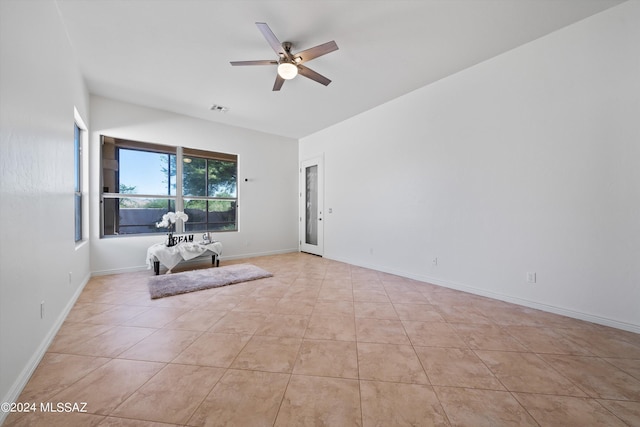 interior space with light tile patterned floors, visible vents, baseboards, and ceiling fan