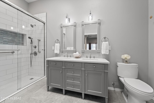 bathroom with a sink, toilet, a stall shower, and double vanity