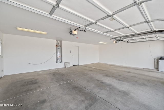 garage featuring gas water heater and a garage door opener