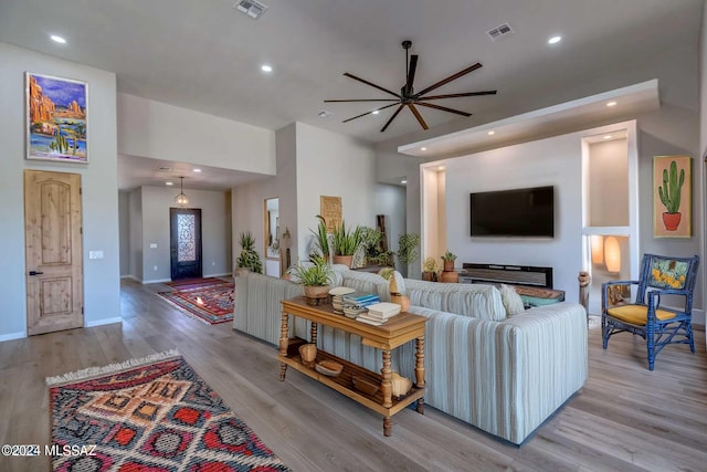 living room featuring ceiling fan and light hardwood / wood-style floors