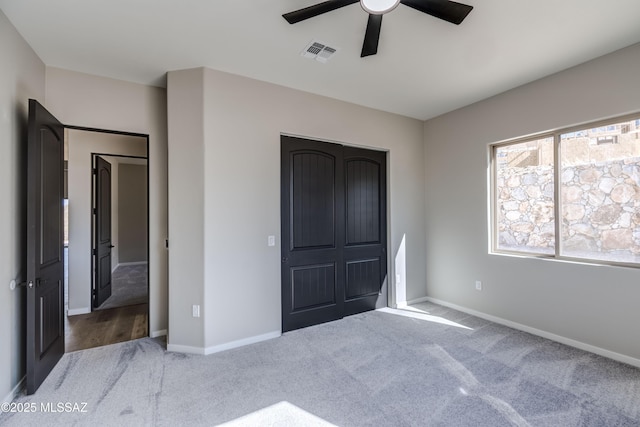 unfurnished bedroom featuring ceiling fan and carpet flooring