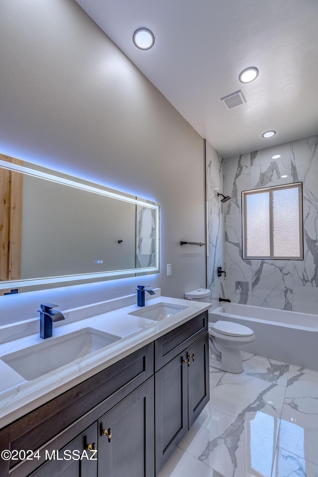 full bathroom featuring tiled shower / bath combo, vanity, and toilet