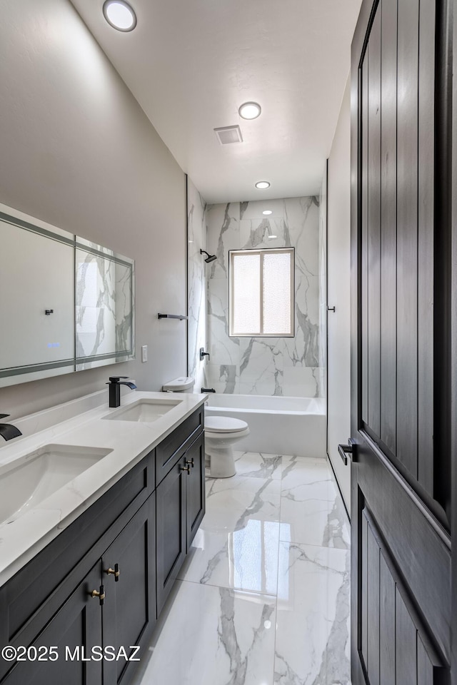 full bathroom featuring vanity, toilet, and tiled shower / bath