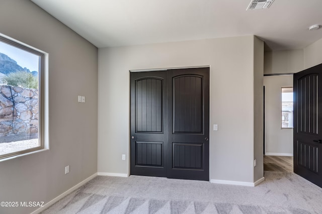 unfurnished bedroom featuring light colored carpet