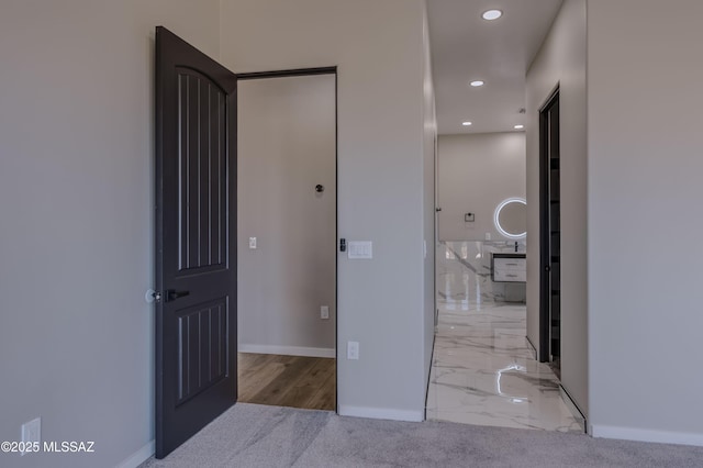 bathroom with a bath, vanity, tile walls, and toilet