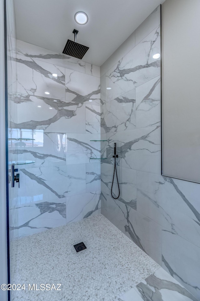 bathroom with a tub to relax in and tile walls