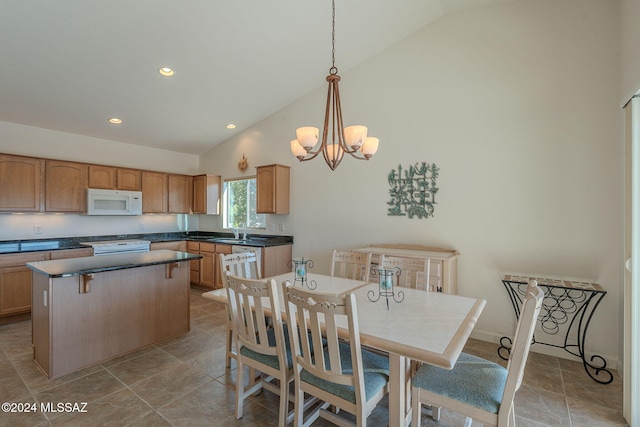 dining room with sink, high vaulted ceiling, and a chandelier