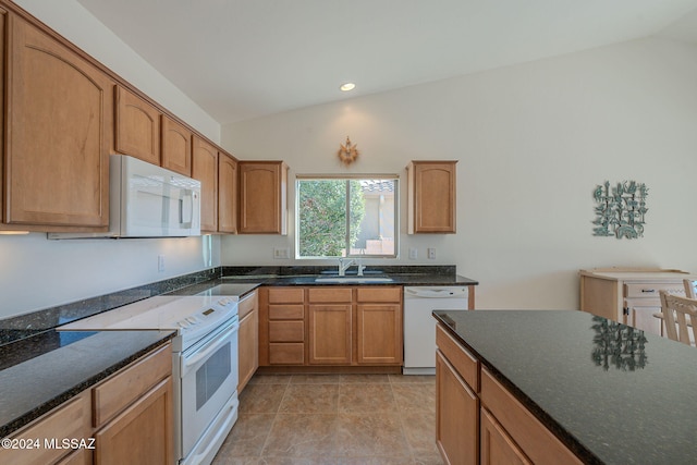 kitchen featuring white appliances, light tile patterned floors, lofted ceiling, and sink