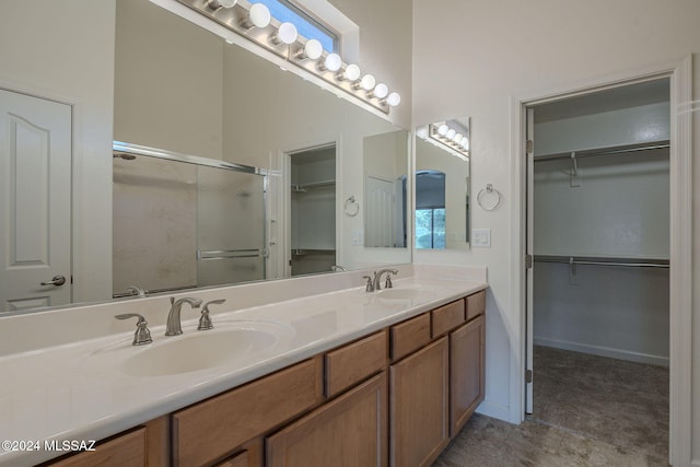 bathroom featuring vanity and a shower with shower door