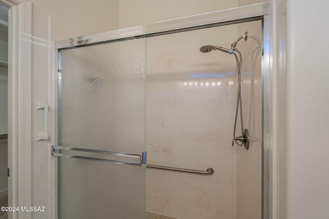 bathroom featuring a shower with door