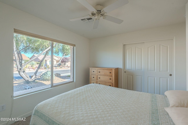 carpeted bedroom with a closet and ceiling fan