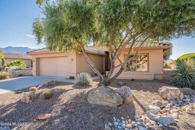 view of front of house featuring a mountain view and a garage