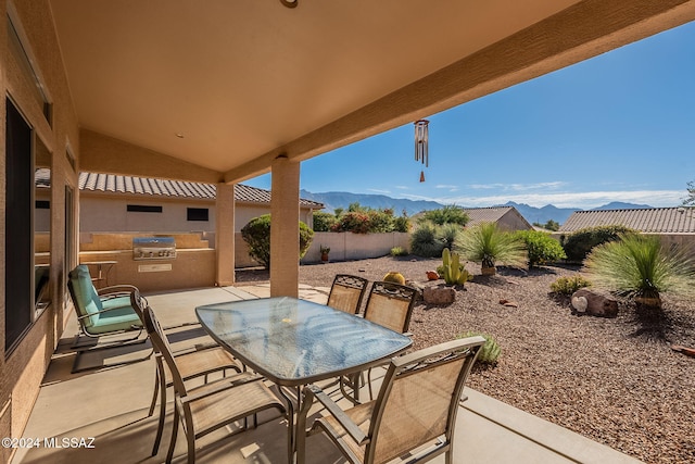 view of patio featuring a mountain view and area for grilling