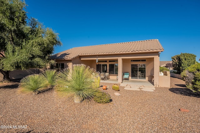 back of property with a patio