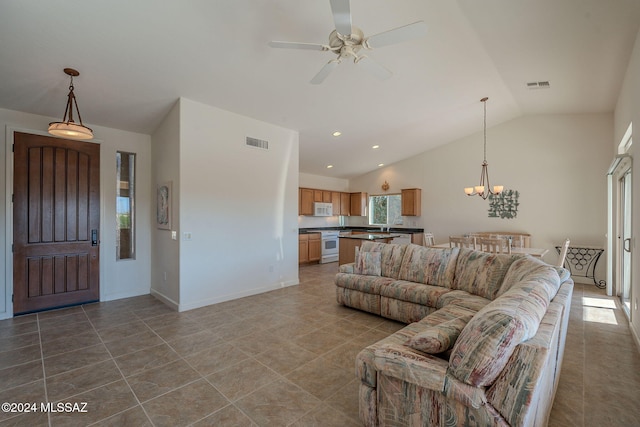 living room featuring light tile patterned floors, ceiling fan with notable chandelier, and vaulted ceiling