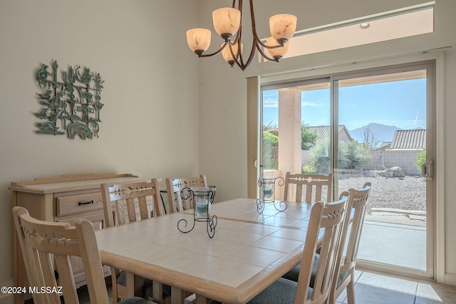 dining room with a mountain view and a chandelier