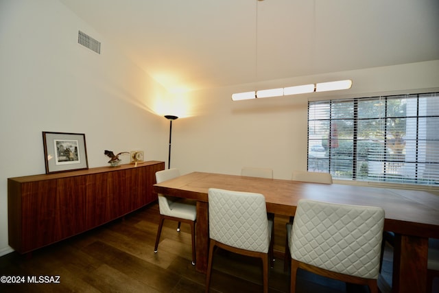 dining area with dark wood-type flooring and visible vents