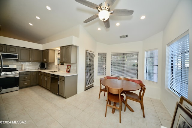 kitchen with stainless steel stove, a sink, visible vents, black dishwasher, and light countertops