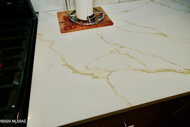 details with wine cooler and light countertops